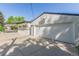 Spacious detached garage with basketball hoop, side door, carport and large driveway at 1570 S Chase St, Lakewood, CO 80232