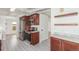 Updated kitchen with stainless appliances and dark wood cabinets at 1570 S Chase St, Lakewood, CO 80232