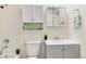 Bright, updated bathroom with a gray vanity, and white tiled shower at 13043 W 20Th Ave, Golden, CO 80401