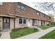 View of townhouse exteriors featuring well-manicured lawns and beautiful brick facades at 13043 W 20Th Ave, Golden, CO 80401