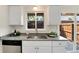 Well-lit kitchen showcasing granite countertops, stainless appliances, and a view of the outdoor patio at 13043 W 20Th Ave, Golden, CO 80401