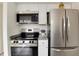 Modern kitchen features stainless steel appliances, including a range, microwave, and refrigerator at 13043 W 20Th Ave, Golden, CO 80401