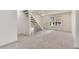 Inviting living room boasts abundant natural light, carpet, and a staircase to the upper level at 13043 W 20Th Ave, Golden, CO 80401