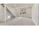 Bright living room featuring neutral carpet, staircase, and an abundance of natural light at 13043 W 20Th Ave, Golden, CO 80401