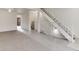 Open-concept living space with neutral carpet and staircase with white railing at 13043 W 20Th Ave, Golden, CO 80401