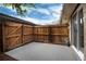 Enclosed patio area featuring a wood fence, concrete floor, and convenient access gate at 13043 W 20Th Ave, Golden, CO 80401