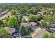 Aerial view of a residential property, showcasing its location within a neighborhood with mature trees and well-kept lawns at 11112 Dahlia Way, Thornton, CO 80233