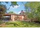 A well-maintained backyard featuring a covered parking area and direct access to the house through an orange door at 11112 Dahlia Way, Thornton, CO 80233