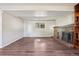 Bright basement space featuring a fireplace, built-in shelves, updated flooring, and a cozy atmosphere at 11112 Dahlia Way, Thornton, CO 80233