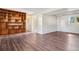 Open basement area with built-in shelving, laminate flooring, and access to additional rooms and storage at 11112 Dahlia Way, Thornton, CO 80233