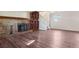 Large basement area with a brick fireplace, built-in shelving, and modern flooring, perfect for entertaining at 11112 Dahlia Way, Thornton, CO 80233