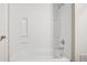 Bathtub and shower combo with recessed shelving at 11112 Dahlia Way, Thornton, CO 80233