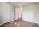 Bedroom featuring modern flooring, neutral walls, and multiple closets for ample storage at 11112 Dahlia Way, Thornton, CO 80233