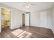 Spacious bedroom with wood-look floors, ceiling fan, closet and bathroom access at 11112 Dahlia Way, Thornton, CO 80233