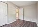 Bedroom featuring neutral walls, modern flooring, an open closet, and a doorway to the hallway at 11112 Dahlia Way, Thornton, CO 80233