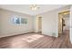 Bedroom with wood-look floors and natural light from the window at 11112 Dahlia Way, Thornton, CO 80233
