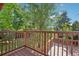 View of a wooden deck overlooking a treed yard at 11112 Dahlia Way, Thornton, CO 80233