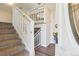 Inviting foyer showcasing a staircase with white railings, laminate floors, and an open doorway at 11112 Dahlia Way, Thornton, CO 80233