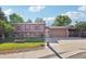 Traditional home with a well-kept lawn, brick accents, and a large driveway leading to an attached garage at 11112 Dahlia Way, Thornton, CO 80233