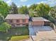Split-level home with a large front yard, a brick garden bed, an asphalt driveway and a 2 car garage at 11112 Dahlia Way, Thornton, CO 80233