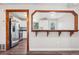 View of the kitchen with stainless steel appliances, white cabinetry, and a charming pass-through bar area at 11112 Dahlia Way, Thornton, CO 80233