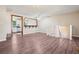 Open living room featuring modern flooring, and adjacent kitchen area at 11112 Dahlia Way, Thornton, CO 80233