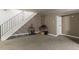 Finished basement with carpet, open staircase, guitars and stereo equipment at 1359 S Chambers Cir # C, Aurora, CO 80012