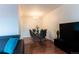 Bright dining room with hardwood floors, modern chandelier, and seating for six at 1359 S Chambers Cir # C, Aurora, CO 80012