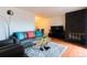 Comfortable living room features a stone fireplace, hardwood floors, and lots of light at 1359 S Chambers Cir # C, Aurora, CO 80012