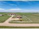 Expansive aerial view of the home nestled in a large, open field with white fencing at 46303 E 106Th Ave, Bennett, CO 80102