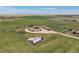 Expansive aerial view of the farmland showcasing the large lot, outbuildings, and open fields for agriculture at 46303 E 106Th Ave, Bennett, CO 80102