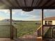 Covered back porch offers scenic views of fenced horse pastures in a serene setting at 46303 E 106Th Ave, Bennett, CO 80102