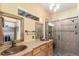 Modern bathroom featuring double copper sinks, granite countertop, and tiled walk-in shower at 46303 E 106Th Ave, Bennett, CO 80102