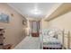Comfortable bedroom featuring a daybed with decorative pillows, lamp, and chest at 46303 E 106Th Ave, Bennett, CO 80102