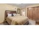 Spacious bedroom featuring a bed, a mirror and closet with doors at 46303 E 106Th Ave, Bennett, CO 80102