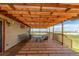 Relaxing covered deck with outdoor seating, string lights, and scenic views at 46303 E 106Th Ave, Bennett, CO 80102