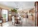 Elegant dining room with round table, striking chandeliers, and beautiful wood cabinets at 46303 E 106Th Ave, Bennett, CO 80102