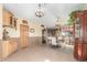 Spacious dining room with tile floor, cabinets, and antler chandeliers at 46303 E 106Th Ave, Bennett, CO 80102