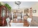 Open-concept dining room featuring a wooden table, antler chandelier and natural light at 46303 E 106Th Ave, Bennett, CO 80102