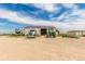 Large storage building with a tractor, semi-truck, and RV parked in front, set on a spacious lot with various farm vehicles at 46303 E 106Th Ave, Bennett, CO 80102