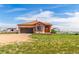 Charming tan single story home with well-manicured lawn at 46303 E 106Th Ave, Bennett, CO 80102