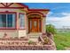 Elegant front door with glass inlay and brick lined garden at 46303 E 106Th Ave, Bennett, CO 80102
