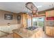 Gourmet kitchen showcasing island with cooktop, granite countertops, custom cabinets, and exterior views at 46303 E 106Th Ave, Bennett, CO 80102