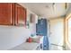 Functional laundry room with utility sink, washer-dryer, and natural light from window at 46303 E 106Th Ave, Bennett, CO 80102