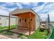Charming wooden shed with porch and unique wood accents, perfect for rural storage at 46303 E 106Th Ave, Bennett, CO 80102