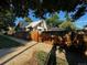 Charming exterior view of home featuring brick and wood siding and a fenced front yard, providing privacy at 1731 E 25Th Ave, Denver, CO 80205