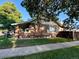 Side view of the brick home with a covered porch and well-kept lawn at 1731 E 25Th Ave, Denver, CO 80205
