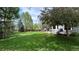 Beautifully maintained backyard with a large lawn, patio area, and mature trees for peaceful outdoor living at 11321 Mesa Verde Pl, Parker, CO 80138