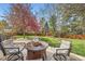 Outdoor space featuring a stone fire pit surrounded by comfortable seating on a stone patio at 11321 Mesa Verde Pl, Parker, CO 80138