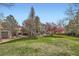 Spacious backyard featuring mature trees, a lush green lawn, and a patio area at 11321 Mesa Verde Pl, Parker, CO 80138